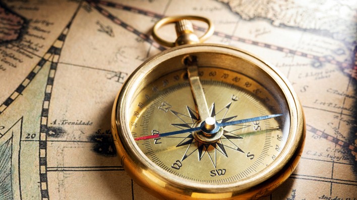 image of a compass on an old map to show the understanding of the spelling of toward has to do with direction