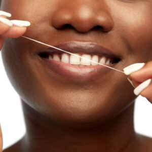 image showing a woman using floss, which is the name of one of the reliable spelling patterns in English.