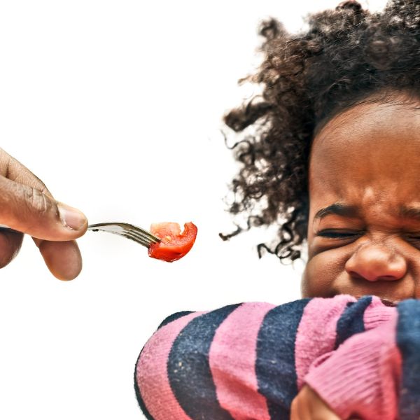 Image of a child who won't try a bite of food to depict the use of the Weird Contraction Won't.